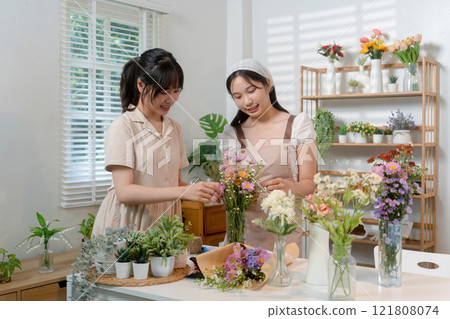 Gardeners florist at her own floral shop taking care of flowers. Gardeners florist at her own floral shop taking care of flowers. 121808074