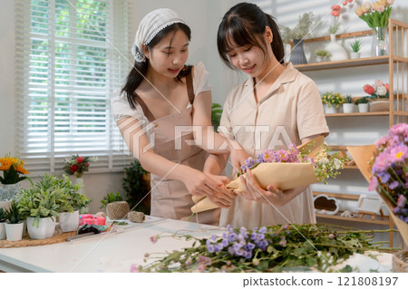 Gardeners florist at her own floral shop taking care of flowers. 121808197