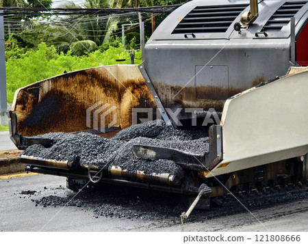 Asphalt paving machine laying down asphalt 121808666