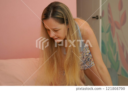 A young woman is enjoying a wonderfully serene morning in her bedroomnd A young woman is enjoying a wonderfully serene morning in her bedroomnd 121808700
