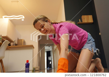A woman is cleaning her living room at home A woman is cleaning her living room at home 121808762
