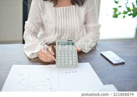 The hands of a middle-aged woman explaining a real estate contract The hands of a middle-aged woman explaining a real estate contract 121808874
