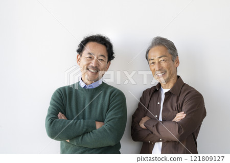 Two senior men smiling at the camera 121809127