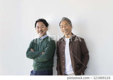 Two senior men smiling at the camera 121809128