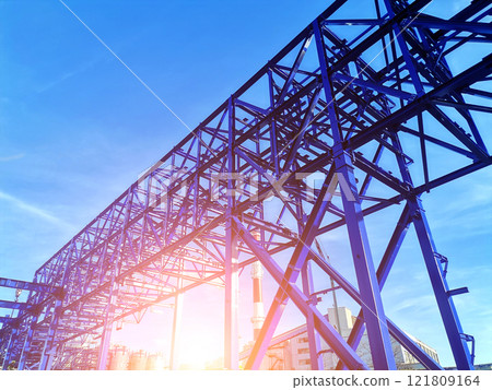 Steel structure is under construction on the construction site against a blue sky backdrop 121809164