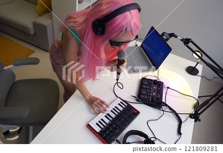 Beautiful young singer and musician broadcast from her home studio Beautiful young singer and musician broadcast from her home studio 121809281