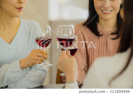 Woman holding a glass of alcohol Woman holding a glass of alcohol 121809489
