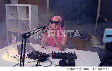 Beautiful young singer and musician broadcast from her home studio 121809512