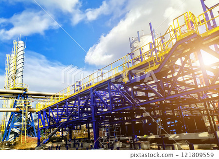 Steel structure is under construction on the construction site against a blue sky backdrop Steel structure is under construction on the construction site against a blue sky backdrop 121809559