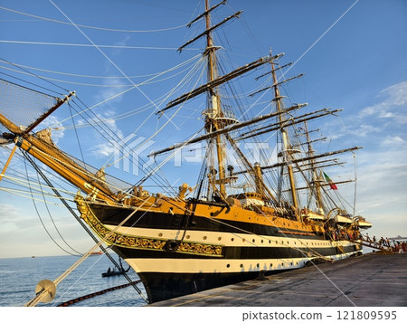A large old ship at pier under a beautiful blue sky A large old ship at pier under a beautiful blue sky 121809595