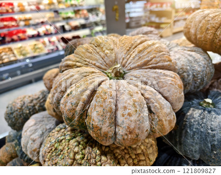 Various types of pumpkins are stacked on top of each other 121809827
