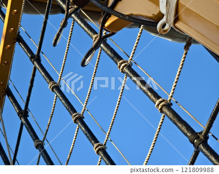Ropes stretched across the masts of an old ship Ropes stretched across the masts of an old ship 121809988