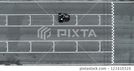 Aerial view Go kart racer cross the finish line, Go kart at circuit start and finish line, Top view race go kart track. Aerial view Go kart racer cross the finish line, Go kart at circuit start and finish line, Top view race go kart track. 121810328