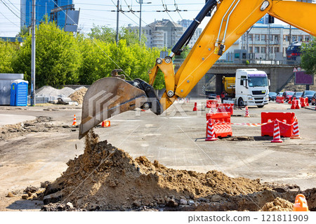 Heavy machinery at work transforming an urban construction site into a new development space 121811909