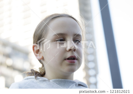Close-up portrait of girl 10 years old. Child on playground. Kids play outdoors. Close-up portrait of girl 10 years old. Child on playground. Kids play outdoors. 121812021