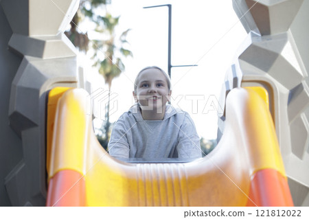 Adorable child girl on playground. Kids play outdoor. Adorable child girl on playground. Kids play outdoor. 121812022