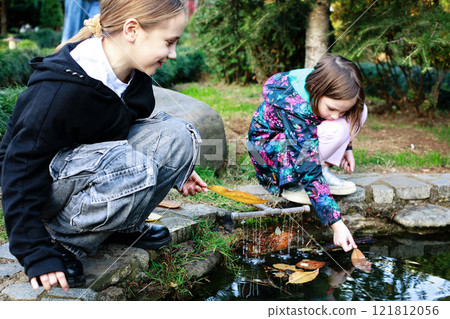 Playful young little girls playing in the park outdoors. Best friend kids Playful young little girls playing in the park outdoors. Best friend kids 121812056