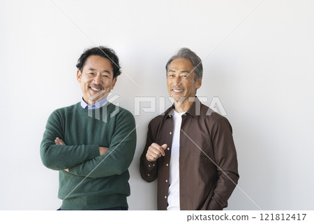 Two senior men smiling at the camera 121812417