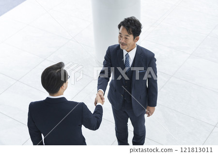 Two businessmen shaking hands Two businessmen shaking hands 121813011