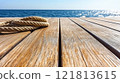 Close-up of a wooden deck with a rope wound on the surface 121813615