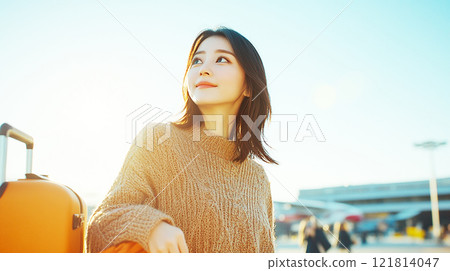 Woman traveling outdoors in bright light 121814047