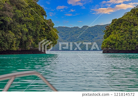 View from a boat of an emerald green lagoon with lush vegetation 121814572