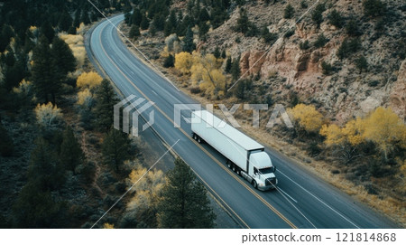 Aerial view of a white semi-truck driving on a winding highway through a scenic forest and rocky landscape in autumn Aerial view of a white semi-truck driving on a winding highway through a scenic forest and rocky landscape in autumn 121814868