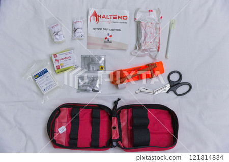 [Ukraine] Contents of a first aid kit laid out on a sticker on a white bed 121814884