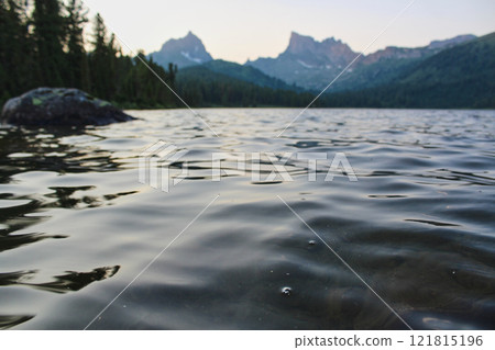 Rippling water in mountain lake. Twilight, shore of pond, Summer landscape 121815196