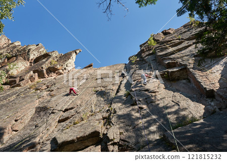 Climber training on natural terrain. Rock climbing in nature Climber training on natural terrain. Rock climbing in nature 121815232