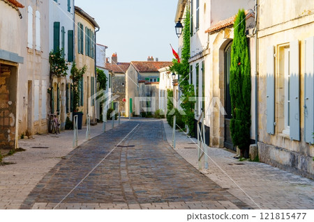 Charming cobblestone street in Saint-Martin-de-Re, a beautiful village on the Sand de Re, France Charming cobblestone street in Saint-Martin-de-Re, a beautiful village on the Sand de Re, France 121815477