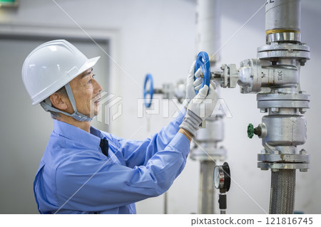 Building maintenance staff image: Profile of a veteran worker inspecting water supply equipment Building maintenance staff image: Profile of a veteran worker inspecting water supply equipment 121816745