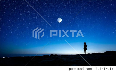 Silhouette of a woman looking up at the moon on a full moon night 121816913