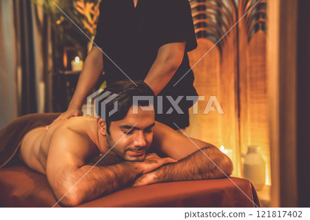 Man customer having exfoliation treatment in luxury spa. Quiescent 121817402