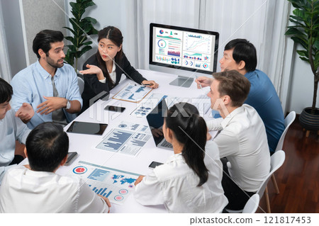 Analyst team utilizing BI Fintech to analyze financial data at table. Prudent 121817453