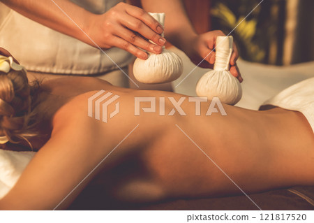 Closeup hot herbal ball spa massage body treatment. Quiescent Closeup hot herbal ball spa massage body treatment. Quiescent 121817520