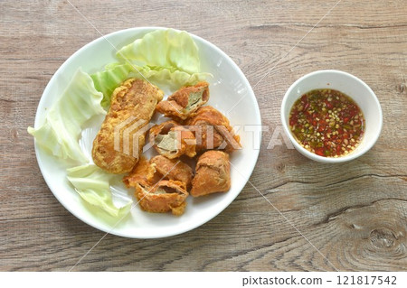fried slice Vietnamese chicken sausage recipe with cabbage on plate dipping spicy sauce fried slice Vietnamese chicken sausage recipe with cabbage on plate dipping spicy sauce 121817542