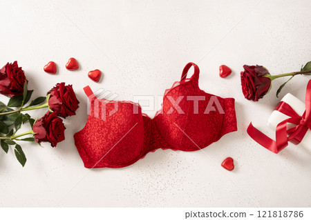 Valentine's day banner with red gift, bustier underwear, wine and chocolate sweets on beige background for Romantic dating. View from above. Copy space. Valentine's day banner with red gift, bustier underwear, wine and chocolate sweets on beige background for Romantic dating. View from above. Copy space. 121818786