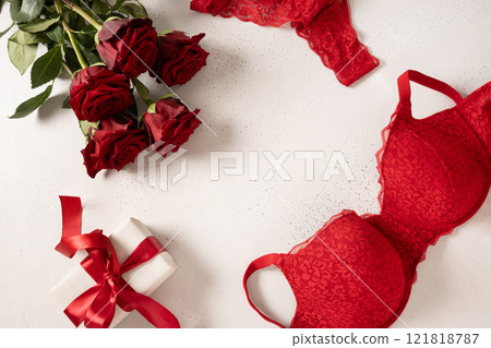 Valentine's day frame with red lace bustier underwear, gifts and red roses on white background. Love. View from above. Copy space. Romantic dating. 121818787