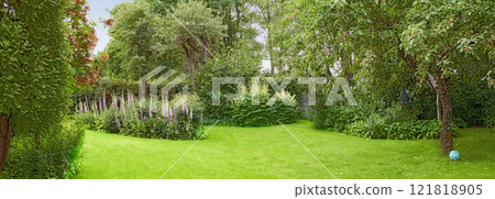 A beautiful nature view of green grass, plants, trees, and flowers. Private outdoor park lawn during spring with a natural background. An outside landscape setting on a peaceful gardening day. A beautiful nature view of green grass, plants, trees, and flowers. Private outdoor park lawn during spring with a natural background. An outside landscape setting on a peaceful gardening day. 121818905