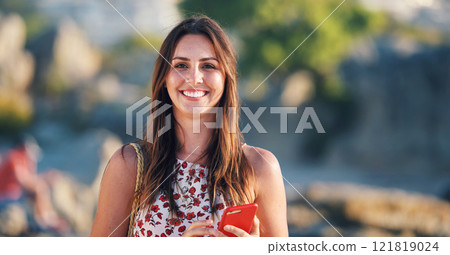 Beautiful woman smiling on beach at sunset holding smartphone enjoying travel vacation lifestyle Beautiful woman smiling on beach at sunset holding smartphone enjoying travel vacation lifestyle 121819024