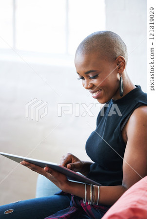 Bald african american woman using digital tablet computer at home Bald african american woman using digital tablet computer at home 121819029