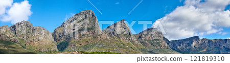 Twelve Apostles at Table Mountain in Cape Town against a blue sky background from below. Breathtaking view of plants and shrubs growing around a majestic rocky valley and scenic landmark in nature Twelve Apostles at Table Mountain in Cape Town against a blue sky background from below. Breathtaking view of plants and shrubs growing around a majestic rocky valley and scenic landmark in nature 121819310