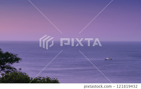 Beautiful sunset view of an open sea, purple sky and the horizon outdoors with copy space. Calm and relaxing ocean scene in the early evening. A colorful seascape with a yacht or sailboat in summer Beautiful sunset view of an open sea, purple sky and the horizon outdoors with copy space. Calm and relaxing ocean scene in the early evening. A colorful seascape with a yacht or sailboat in summer 121819432