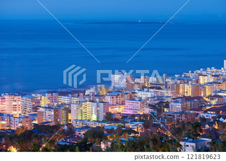 Beautiful sunset sky over a cityscape view as seen from Signal Hill in Cape Town, South Africa. Scenic panoramic landscape of lights illuminating an urban metropolitan skyline along the sea 121819623