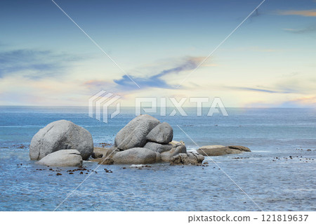 Copyspace at sea with a cloudy blue sky background and rocky coast in Western Cape South Africa. View of calm scenic sea landscape with rocks. Stunning destination for a summer holiday background 121819637