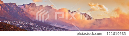 Beautiful sunrise panorama with mist over a mountain. Foggy weather along the coast at dawn. Breathtaking view of a peaceful suburb surrounded by majestic valley and scenic landscape in nature 121819683