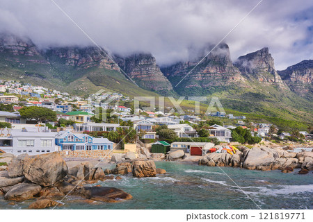 Landscape view of a seaside town along the mountain on a cloudy day in Cape Town, South Africa. Scenic view of a quiet and secluded residential area on the coast for tourists and holidays in summer 121819771