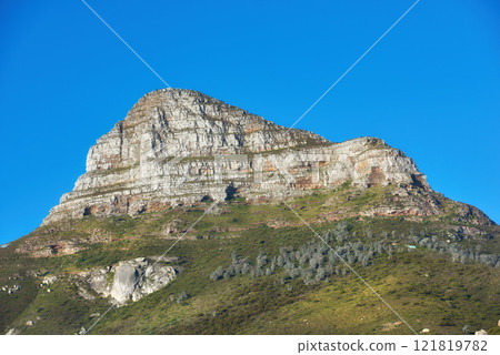 Beautiful Lions Head mountain on clear blue sky with copy space. Summer landscape of mountains with hills covered in green grass or bushes at a tourism sightseeing location in Cape Town, South Africa Beautiful Lions Head mountain on clear blue sky with copy space. Summer landscape of mountains with hills covered in green grass or bushes at a tourism sightseeing location in Cape Town, South Africa 121819782