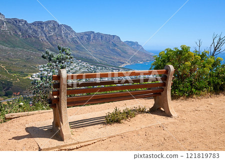 Relaxing resting place along a mountain trail, with beauty in nature and peaceful harmony. Empty bench on Table Mountain, Cape Town, South Africa with a beautiful view of Lions Head and copy space. 121819783